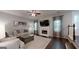 A comfortable living room with fireplace, neutral-toned furniture, and elegant curtains at 30 Saint Charles Pl, Sharpsburg, GA 30277