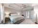 Serene main bedroom featuring a tray ceiling, carpet floors, and a doorway to the ensuite bathroom at 30 Saint Charles Pl, Sharpsburg, GA 30277