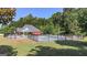 Community pool with chairs, umbrellas, and brick pool house surrounded by green grass and trees at 30 Saint Charles Pl, Sharpsburg, GA 30277