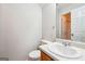 Bright bathroom features a white vanity, toilet, and a shower with a glass door at 4448 Janice Dr, Snellville, GA 30039
