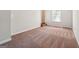 Bedroom featuring neutral walls, carpet, base trim, large window and stairway to the side at 4448 Janice Dr, Snellville, GA 30039