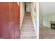Welcoming entryway with carpeted stairs leading to the upper level, providing a warm and inviting transition at 4448 Janice Dr, Snellville, GA 30039