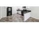 Functional kitchen featuring white cabinets, stainless steel appliances, and black countertops, designed for efficiency at 4448 Janice Dr, Snellville, GA 30039
