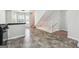 Open-concept living area with tile floors, steps to the upper level, and a pass-through to the kitchen at 4448 Janice Dr, Snellville, GA 30039
