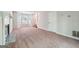 Spacious living room with a cozy fireplace, large windows for natural light, and carpeted flooring at 4448 Janice Dr, Snellville, GA 30039