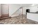 Spacious living area with tiled flooring and steps leading to upper floors, providing easy access throughout at 4448 Janice Dr, Snellville, GA 30039