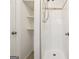 Enclosed shower features white tile and shelves outside the shower for easy access at 4448 Janice Dr, Snellville, GA 30039