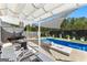 Relaxing backyard features a modern pool, stylish pergola, and comfortable lounging area at 65 Hill Top Cir, Grantville, GA 30220