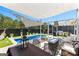 Backyard with a pool, pergola, dining area, outdoor kitchen, and lounge area at 65 Hill Top Cir, Grantville, GA 30220
