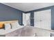 Comfortable carpeted bedroom with a double door closet and soothing navy blue walls at 65 Hill Top Cir, Grantville, GA 30220