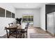 Bright dining room with wood table, stylish decor, and sliding glass doors leading to the outdoor pool at 65 Hill Top Cir, Grantville, GA 30220