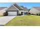 Charming single-Gathering home featuring a stone accents, a well-manicured lawn, and a two-car garage at 65 Hill Top Cir, Grantville, GA 30220