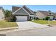 Well maintained single-Gathering home featuring a manicured lawn, two-car garage and concrete driveway at 65 Hill Top Cir, Grantville, GA 30220