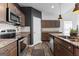 Updated kitchen with stainless steel appliances, granite countertops, and a breakfast bar at 65 Hill Top Cir, Grantville, GA 30220