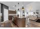 Modern kitchen with an island, granite countertops, pendant lighting, and an open floorplan at 65 Hill Top Cir, Grantville, GA 30220