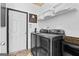 Well-organized laundry room with modern washer and dryer, shelving, and decorative accents at 65 Hill Top Cir, Grantville, GA 30220