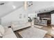 Bright, open living space flows into the kitchen with modern bar seating and hardwood floors at 65 Hill Top Cir, Grantville, GA 30220