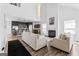 Open-concept living room with fireplace, high ceilings, modern lighting, and wood-look floors at 65 Hill Top Cir, Grantville, GA 30220