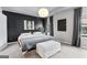Stylish main bedroom featuring a dark accent wall, plush bedding, and modern decor at 65 Hill Top Cir, Grantville, GA 30220