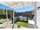 Outdoor kitchen on a concrete patio has stainless steel appliances, a grill, and artificial turf at 65 Hill Top Cir, Grantville, GA 30220