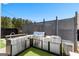 Outdoor kitchen has stainless steel appliances, a grill, and sink on a concrete patio at 65 Hill Top Cir, Grantville, GA 30220