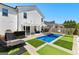 Beautiful backyard featuring a private pool, luxurious lounge area, and well manicured landscaping at 65 Hill Top Cir, Grantville, GA 30220