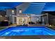 Backyard at night featuring a pristine pool and patio area with a pergola lit with string lights at 65 Hill Top Cir, Grantville, GA 30220