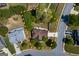 An aerial shot showcasing property lines, roof, yard with mature trees, and neighborhood context of the property at 1212 Dayspring Trce, Lawrenceville, GA 30045