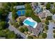 An aerial view of community amenities: swimming pool, tennis courts, playground, and clubhouse at 1212 Dayspring Trce, Lawrenceville, GA 30045