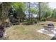 Backyard view with a wooden storage shed and patio dining set at 1212 Dayspring Trce, Lawrenceville, GA 30045