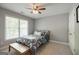 Cozy bedroom featuring a ceiling fan, closet and a large window at 1212 Dayspring Trce, Lawrenceville, GA 30045