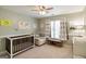 Charming Bedroom features a white crib and glider, complemented by neutral walls and natural light at 1212 Dayspring Trce, Lawrenceville, GA 30045