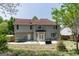 Rear exterior view with a patio, well-maintained yard, and partial fence and tree line at 1212 Dayspring Trce, Lawrenceville, GA 30045