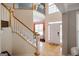 Bright, two-story foyer with hardwood floors, staircase, and ample natural light streaming through large windows at 1212 Dayspring Trce, Lawrenceville, GA 30045