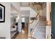 Grand foyer with hardwood floors, staircase, and views into the formal living room at 1212 Dayspring Trce, Lawrenceville, GA 30045