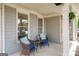 Inviting front porch with comfortable seating, decorative plants, and classic architectural details at 1212 Dayspring Trce, Lawrenceville, GA 30045