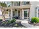 Cozy front porch features comfortable seating, decorative plants, and a welcoming entrance with a glass-paneled door at 1212 Dayspring Trce, Lawrenceville, GA 30045