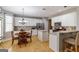 Bright eat-in kitchen with white cabinets, stainless steel appliances and breakfast bar at 1212 Dayspring Trce, Lawrenceville, GA 30045