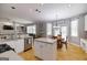 Open eat-in kitchen featuring stainless steel appliances and views to the living room at 1212 Dayspring Trce, Lawrenceville, GA 30045