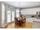 Eat-in kitchen area with wooden table, white cabinets, and access to the backyard at 1212 Dayspring Trce, Lawrenceville, GA 30045