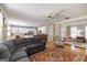 Open-concept living space with hardwood floors, a large sectional sofa, and seamless flow to the kitchen at 1212 Dayspring Trce, Lawrenceville, GA 30045