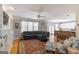 Open living room features a large sectional, built-in shelving, and hardwood floors at 1212 Dayspring Trce, Lawrenceville, GA 30045