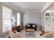 Cozy sitting area with neutral decor, comfortable seating, and bright natural light from the windows at 1212 Dayspring Trce, Lawrenceville, GA 30045