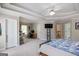 Large main bedroom with a tray ceiling, a fan, and ensuite bathroom at 1212 Dayspring Trce, Lawrenceville, GA 30045