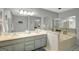 The bathroom features a double vanity, a large mirror and a soaking tub providing a relaxing oasis at 100 Ashland Trl, Tyrone, GA 30290