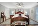 Spacious main bedroom with a ceiling fan, matching dressers, and large windows at 100 Ashland Trl, Tyrone, GA 30290