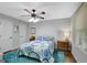 Bright bedroom featuring a white metal bed frame, ceiling fan and an area rug providing comfort and style at 100 Ashland Trl, Tyrone, GA 30290