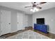 Spacious bedroom featuring hardwood floors, ceiling fan, and a blue dresser with a TV at 100 Ashland Trl, Tyrone, GA 30290