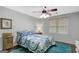 Bright bedroom featuring a white metal bed frame, ceiling fan and a window providing ample natural light at 100 Ashland Trl, Tyrone, GA 30290