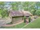 Home exterior showcasing a brick walkway, manicured lawn, garage and pergola for an elegant touch at 100 Ashland Trl, Tyrone, GA 30290
